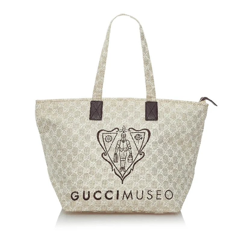 Women Gucci bags with a snap - button closure and a decorative charmGucci GG Canvas Museo Tote Bag